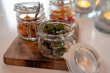 Glass jars with healthy party snacks served in bar, tasty appetisers