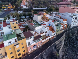 Aerial view on colorful houses and black lava rocks in small village Punta Brava near Puerto de la Cruz, Tenerife, Canary islands at sunrise
