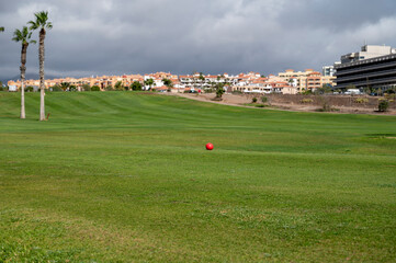 Green lawn grass on year-round outdoor golf course located nead yacht harbor on Tenerife, Canary...