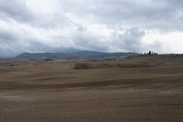 View on hills of Tuscany, Italy. Tuscan landscape with ploughed fields in autumn.