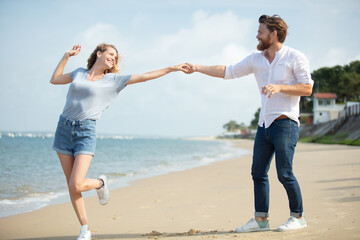 young couple taking selfie on sea beach