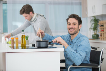 man in the wheelchair cooking in the kitchen