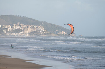 Water sport at cold winter water of Tyrrhenian sea between two touristic towns Sperlonga and Terracina in Lazio, Italy