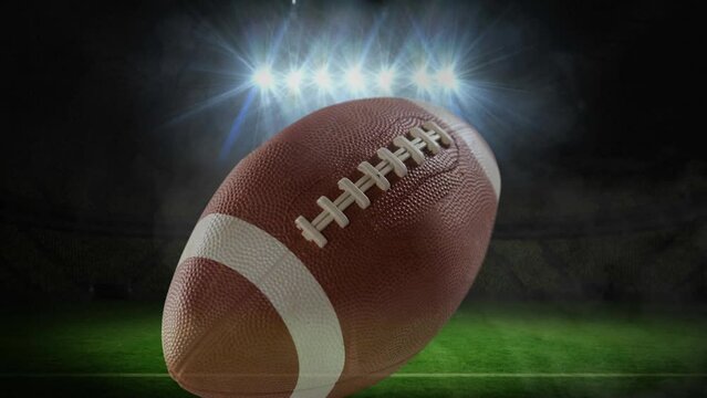 Animation of american football ball over stadium lights