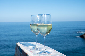 Drinking of white wine with view on blue Atlantic ocean on Tenerife, Canary islands, Spain