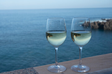 Drinking of white wine with view on blue Atlantic ocean on Tenerife, Canary islands, Spain