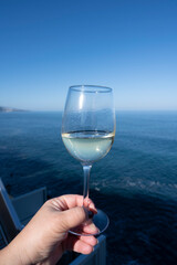 Drinking of white wine with view on blue Atlantic ocean on Tenerife, Canary islands, Spain