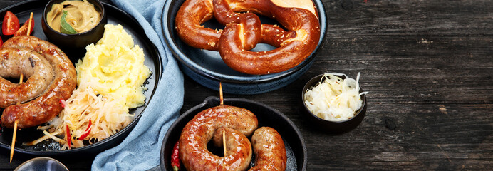 Grilled German sausages on wooden background.