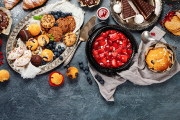 Dessert table with all kinds of cakes and snacks.