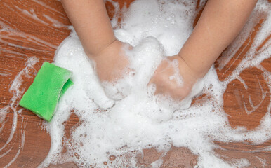 Fototapeta premium The boy plays with soap suds