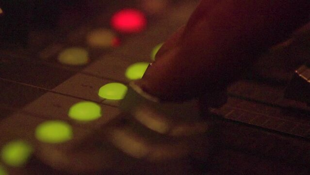 Professional multitrack sound recording, setting levels. Dimmed light