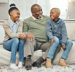 Thats how we did things back in the day. Shot of a grandfather bonding with his grandkids on a sofa...