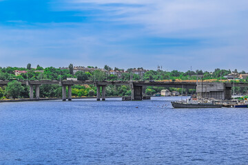 Fototapeta premium View of the Inhulskyy Mist bridge from the Pedestrian bridge across the Inhul river in Mykolaiv, Ukraine. Urban panorama of Ukrainian town