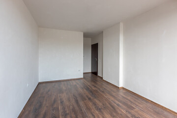 Fototapeta na wymiar Empty bright living room. New home. Beautiful apartment interior. Wooden floor