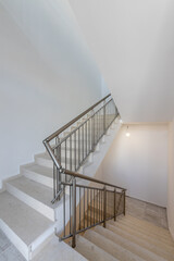 Modern stair case between floors. Stairs with metallic rail  in modern building