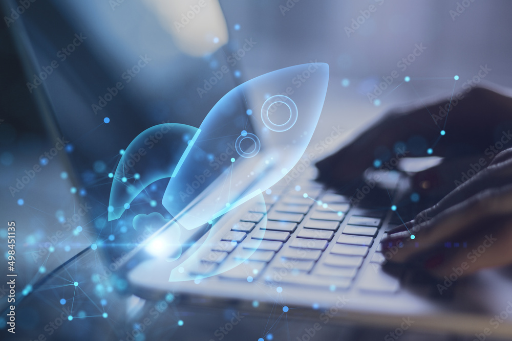 Poster close up of backlit hands using laptop with abstract glowing blue rocket space ship on blurry backgr