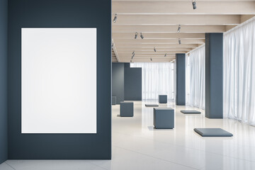 Blank white poster on grey wall in the foreground of modern and stylish empty exhibition hall with stands on marble floor and big windows. Presentation concept. 3D rendering, mock up