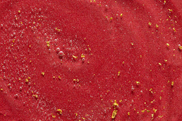 Transparent cosmetic gel with gold  speck on red backgrpund , skin care treatment. Flat lay