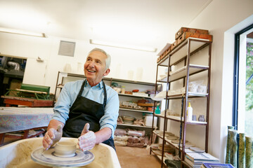 Do more things that make you happy. Shot of a senior man making a ceramic pot in a workshop.