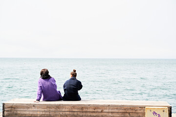 couple sitting on the pier