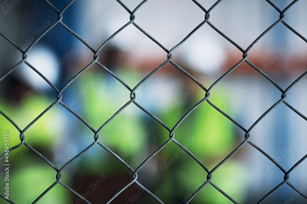 Aufkleber Keep your site secure at all costs. Shot of a group of unrecognisable builders inspecting a construction site behind a fence.