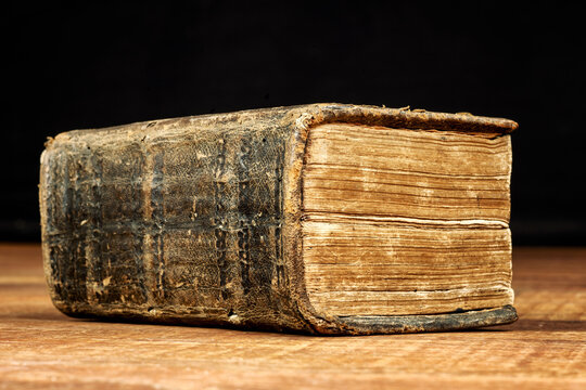 Big thick closed book against a black background