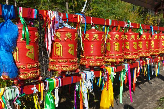 Buddhist prayer red drums near the statue of the Medical Buddha in the Arshan sanatorium in Buryatia