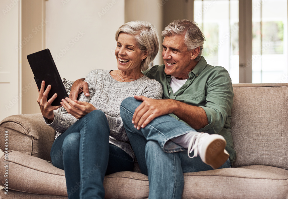 Poster we dont know a television anymore. cropped shot of a cheerful senior couple browsing on a digital ta