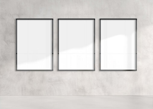 Three billboards hanging on a sunlit wall mockup. Template of frames bathed in sunlight 3D rendering
