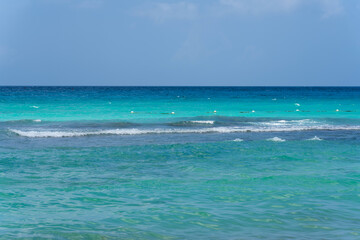 Seascape. Turquoise sea and clear blue sky. A motorboat rushes on the horizon