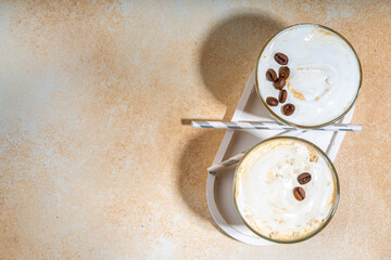 Cold dairy coffee drink with milk, whipped cream. Foamy frappe, latte, cappuccino, on a cream...