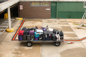 Trolley full of bags, suitcases and other luggage awaiting loading