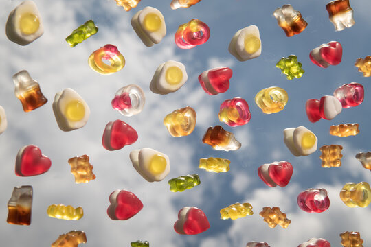 abstract fine art photo of colorful candy on mirror reflecting the sky