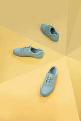 Stylish green sneakers concept with mirror isolated on yellow background, space for text