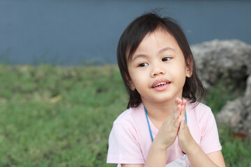 Positive charming 4 years old cute baby Asian girl, little preschooler child smiling and looking to the left