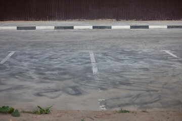 Parking space for the car. Empty parking on the street. Dirty parking covered with sand.