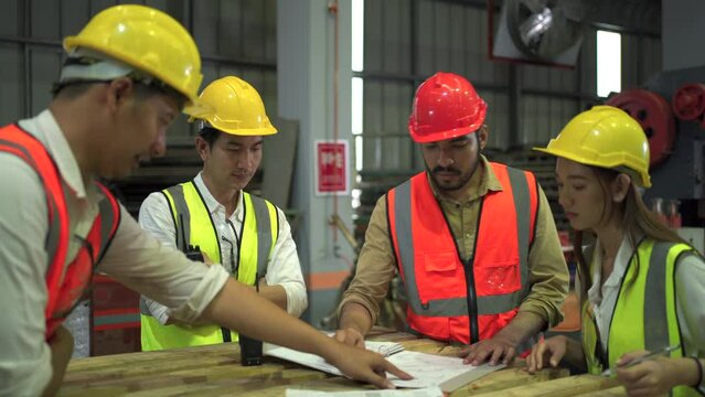 Team of professional engineer and foreman making a team discussion together before starting the project. 