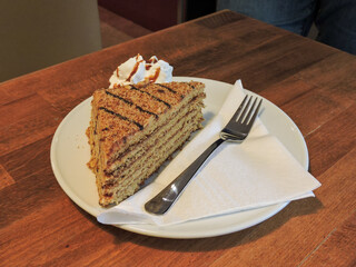 Huge Piece of Layered Cake in Austria with Fork and Plate