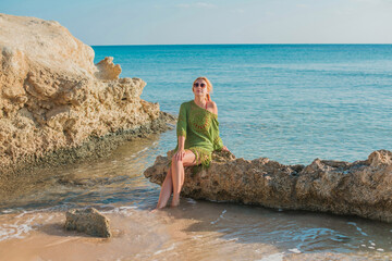 Summer season, vacation at sea, ocean. Woman take a rest on shore. Pretty nice landscape view