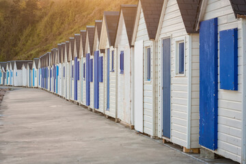 Row of blue and white beach huts at Barneville-Carteret, France