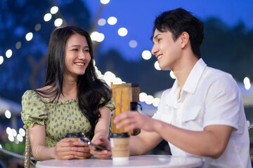 Image of young Asian couple dating at coffee shop