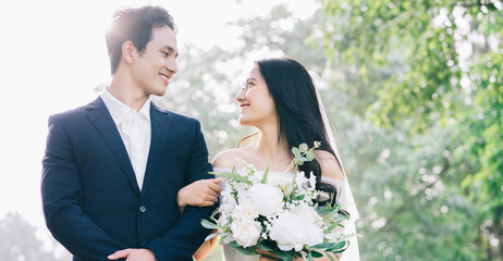 Image of young Asian bride and groom