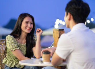 Image of young Asian couple dating at coffee shop