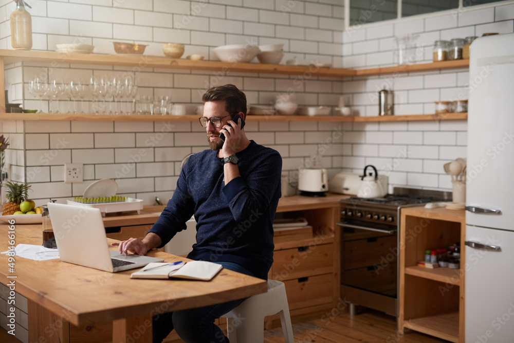 Aufkleber hes great at multitasking. cropped shot of a handsome young businessman making a phonecall while sit