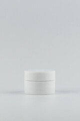 Skincare and cosmetology vertical mockup. Unbranded white plastic jar for cosmetics products. Branding identity template for text and design