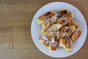 Home baking. Croissants on a white plate. Home, rural cozy kitchen table. Breakfast. Place for text. Delicious. Sweet food. Selective focus