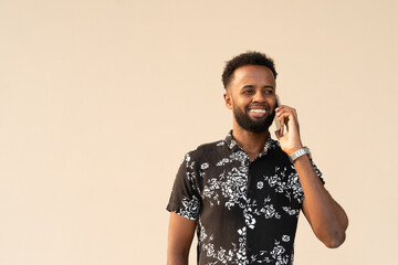 Portrait of handsome young African man using mobile phone