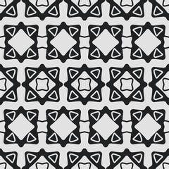 Abstract black and white tiles. Vector seamless tile of identical ornamental shapes.