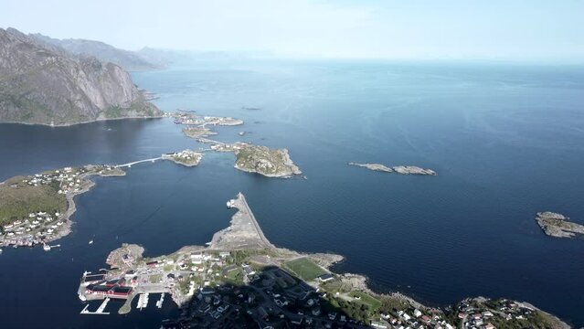 Flying at Reinbringen, Lofoten overlooking the islands of Reine and the ocean, as well as the mountain chains of the Lofoten islands in the background.