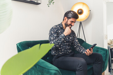 happy man reading good news in his mobile phone and celebrating success concept medium full shot...